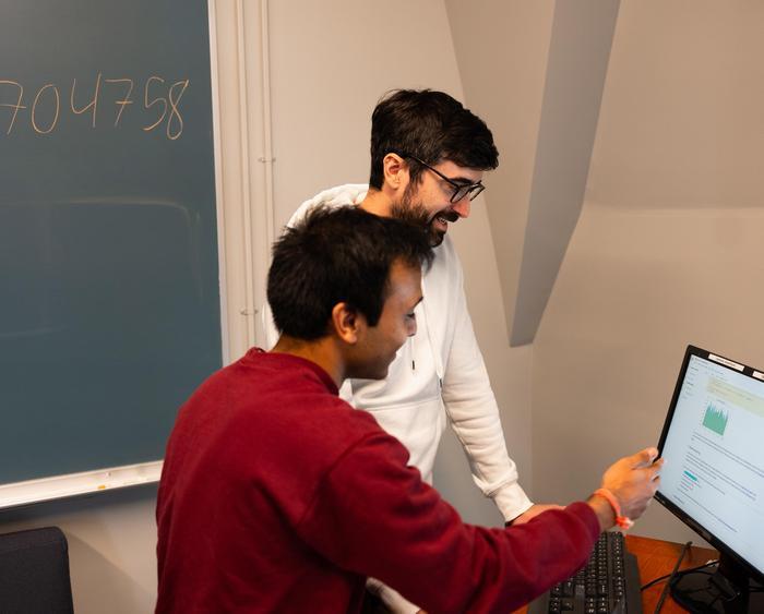 students and professor working in a lab