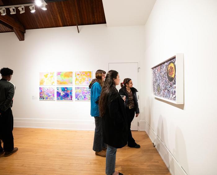 people in an art gallery observing the works