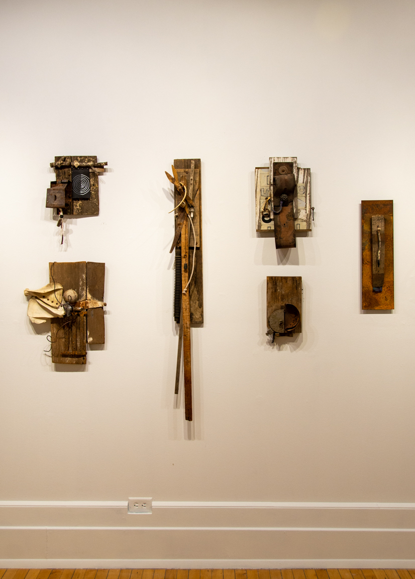a selection of sculptures hanging on a wall