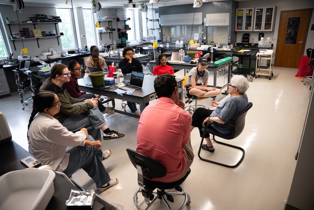 group sitting in a circle in a lab