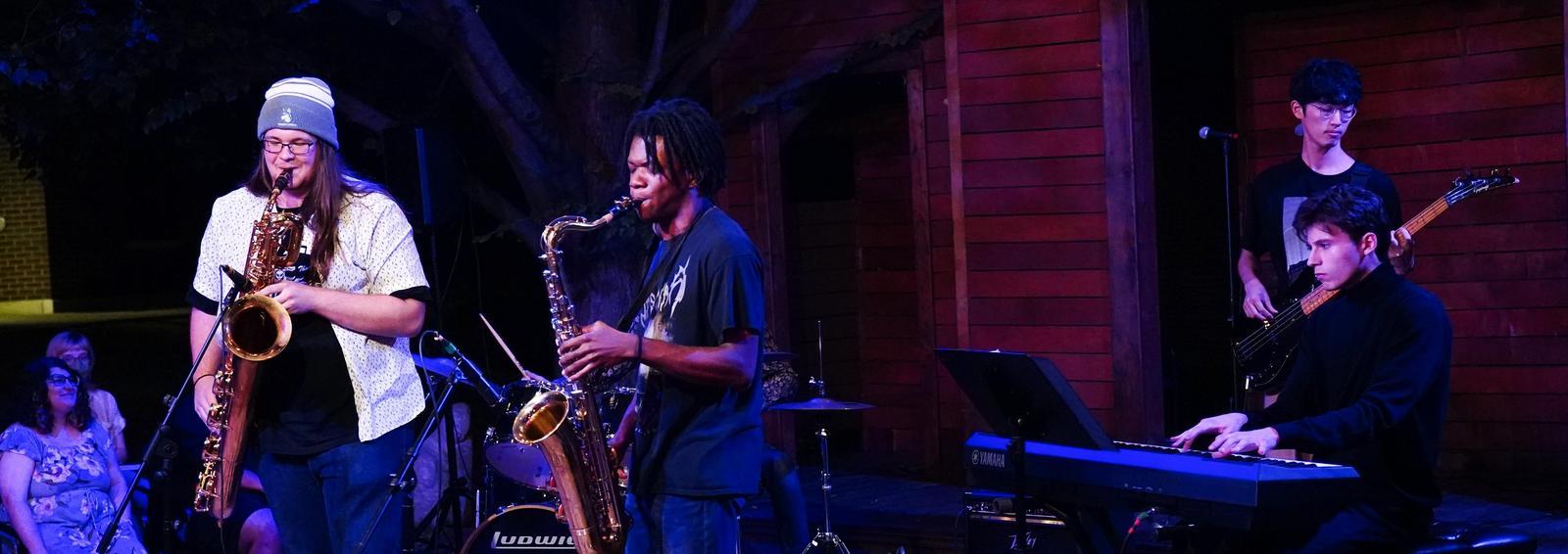 students play music in the grove