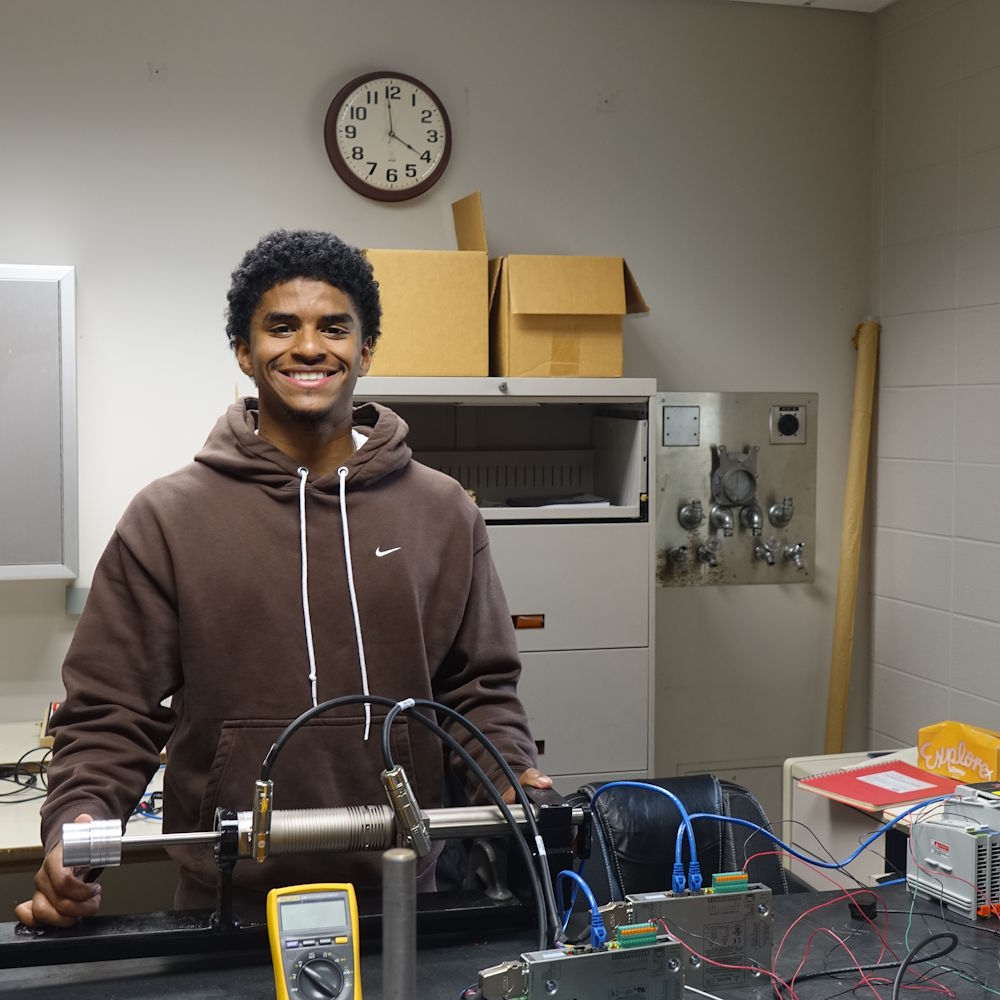 Elijah Bull in a physics lab with lab equipment
