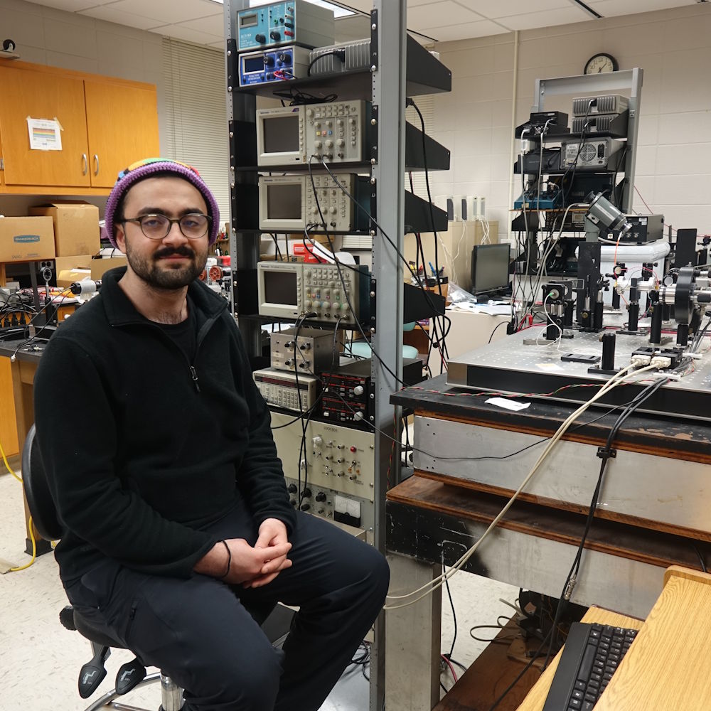 Mahmood Alwash in a physics lab with lab equipment