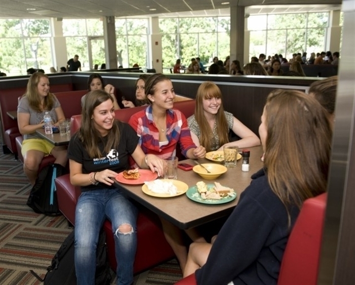 Students seated at booth in dining hall