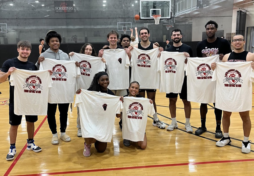 The winning team of the intramural basketball league in a large gymnasium