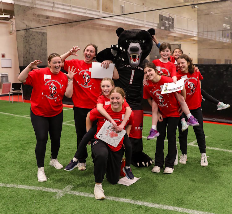 people posing with Boomer the Bear, the Lake Forest College mascot