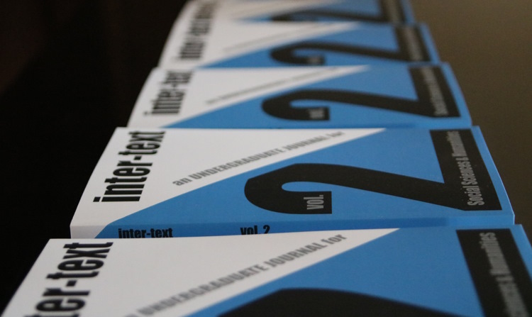 copies of inter-text volume 2 lined up on a table