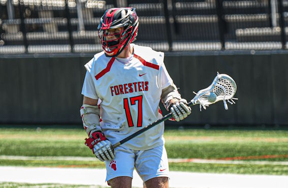 the women's hockey team celebrating on the ice with a trophy