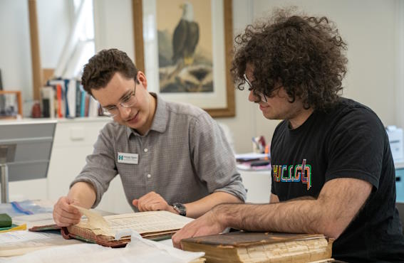 student working with historical documents at an internship