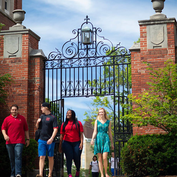 students walking through the Harlan and Blackstone gates on campus