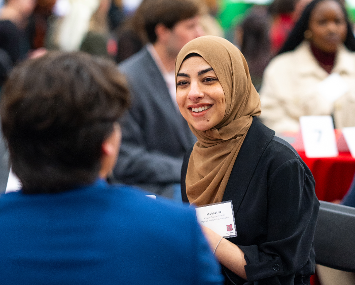 a student in a conversation at Speed Networking