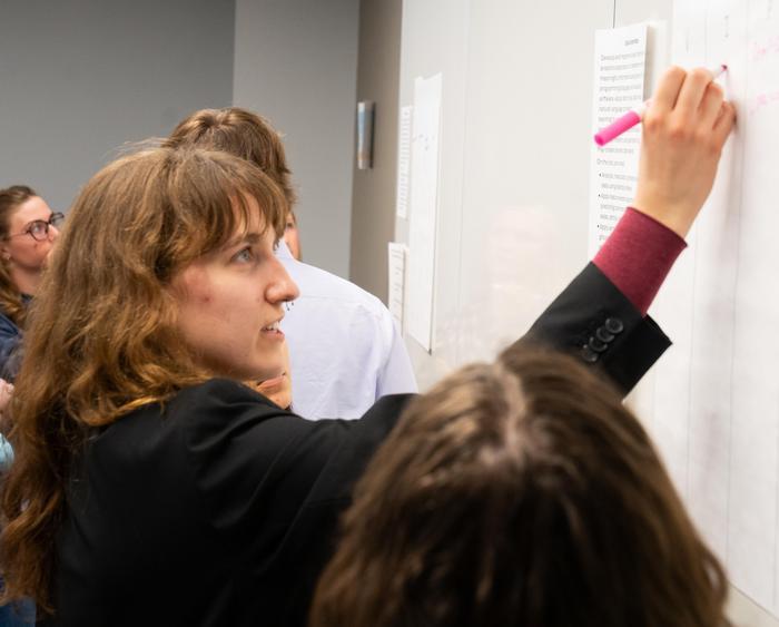 student writing on board