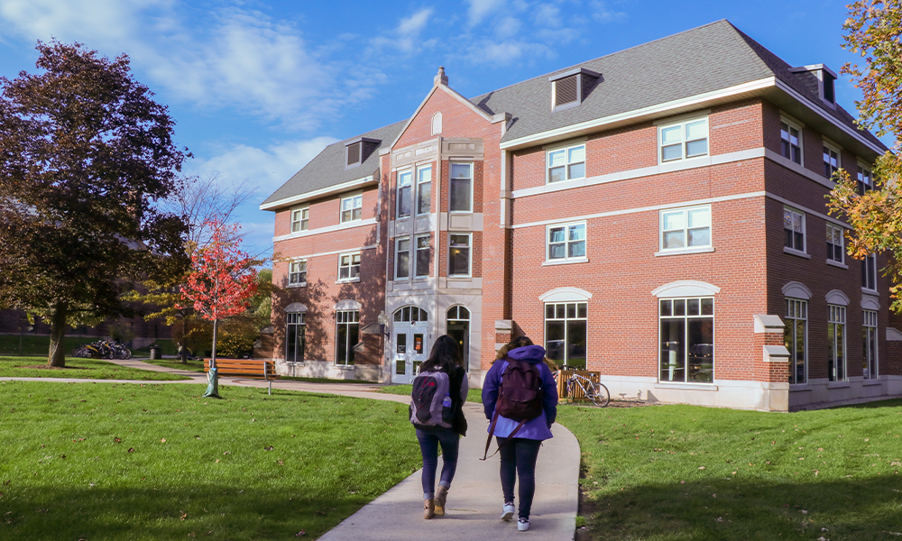 2 students walking toward deerpath hall