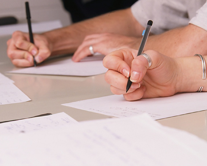 Students writing on paper