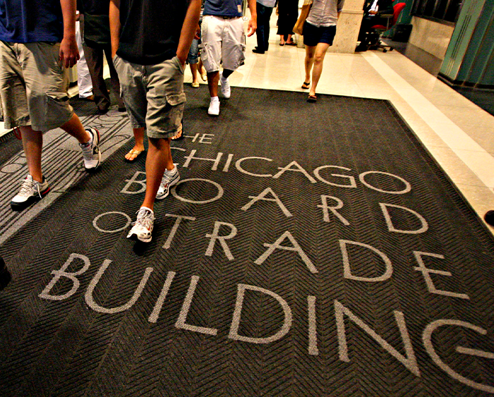 feet on sidewalk sign saying Chicago Board of Trade