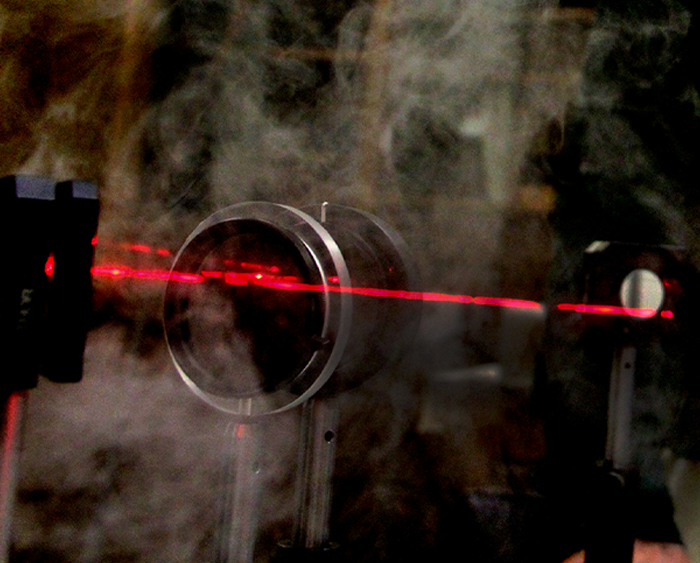 a laser, mirror, and smoke