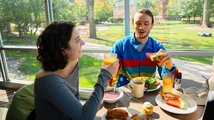 two students eating in the dining hall
