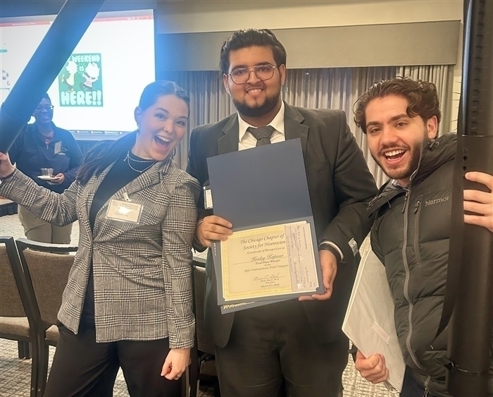 three students at conference