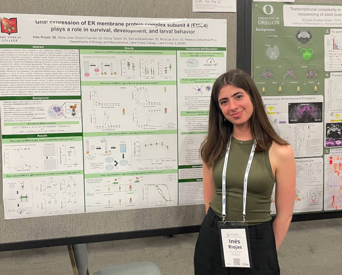 ines in front of her poster