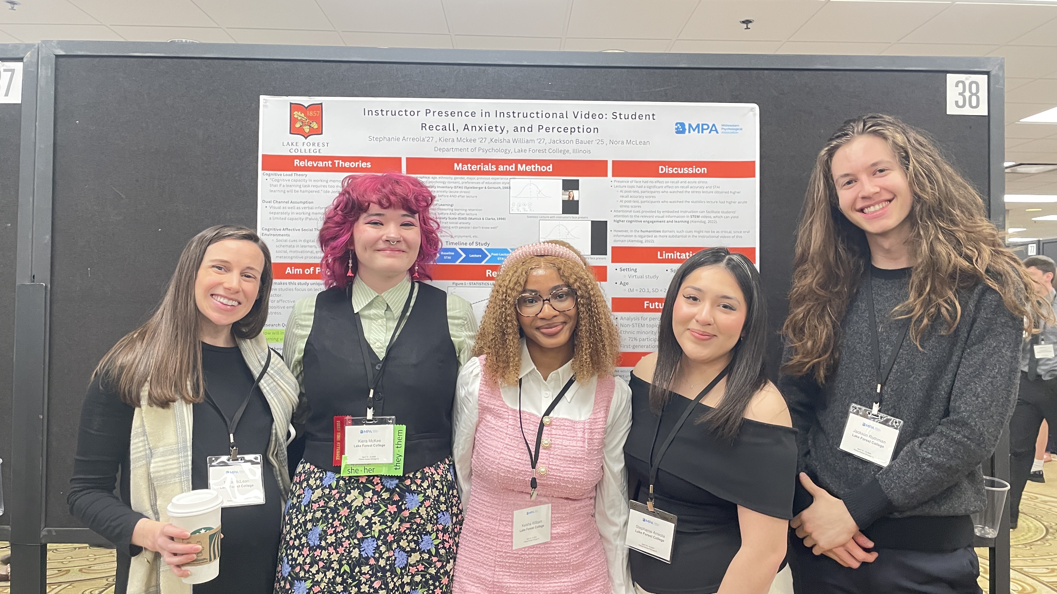 students standing before their poster