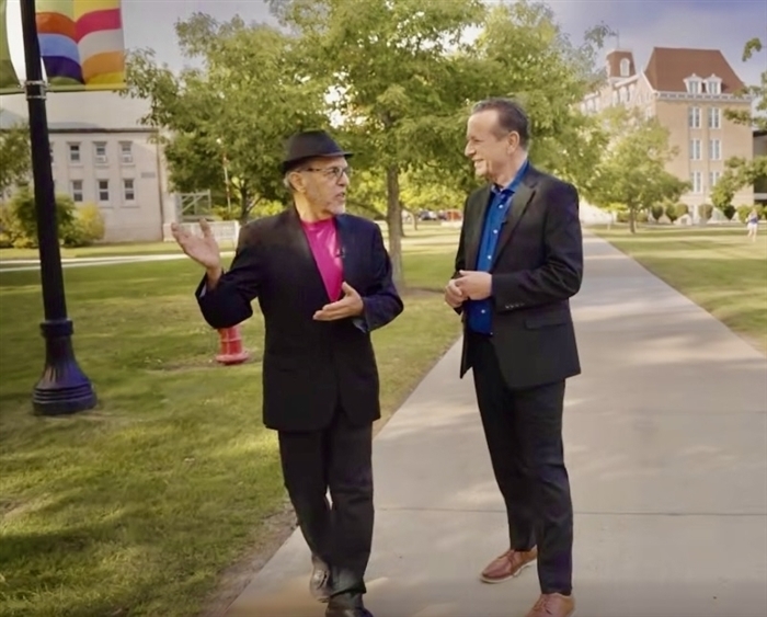 two men walking on campus