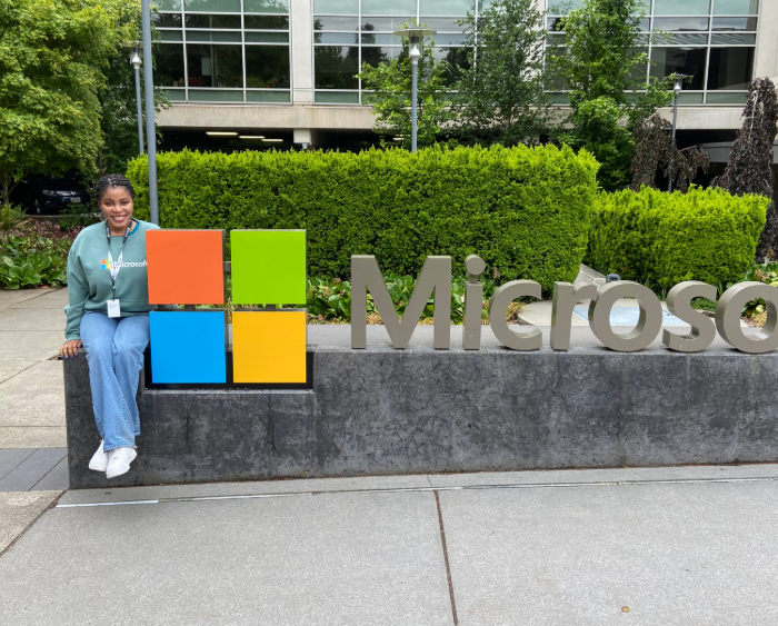 dossa posing by a microsoft sign
