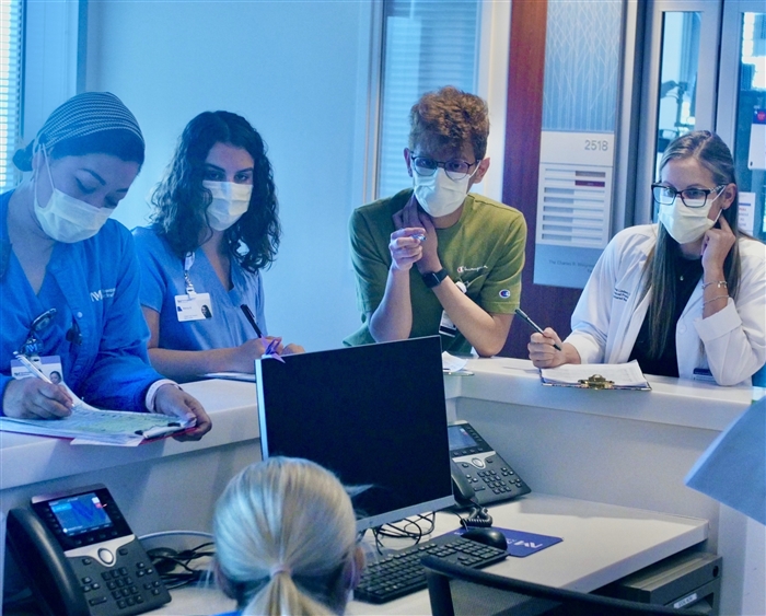 students learning from nurses at a hospital