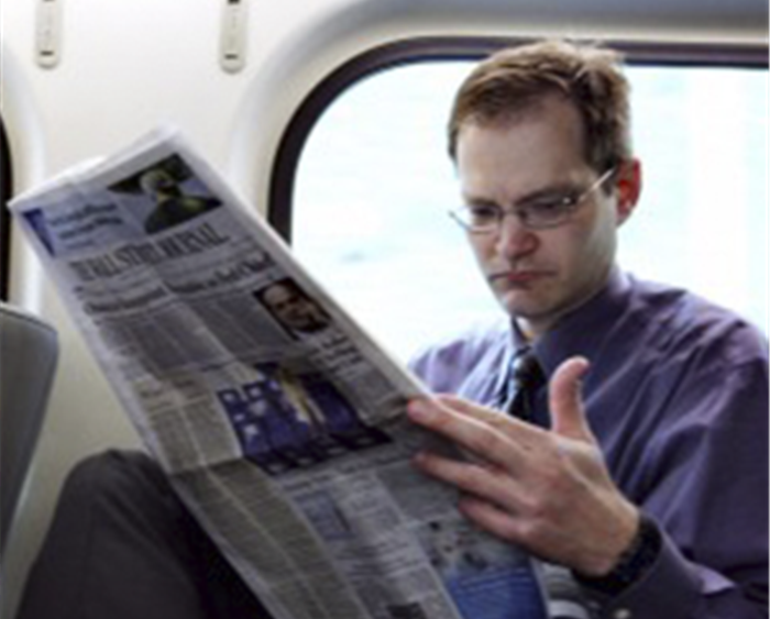 Kent Grote reading paper on train