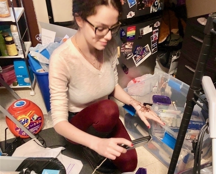 Student FaceTimes amid dorm room contents