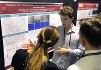 student presenting at a poster session